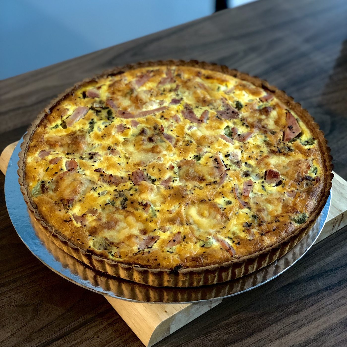 A whole quiche in a fluted dish
