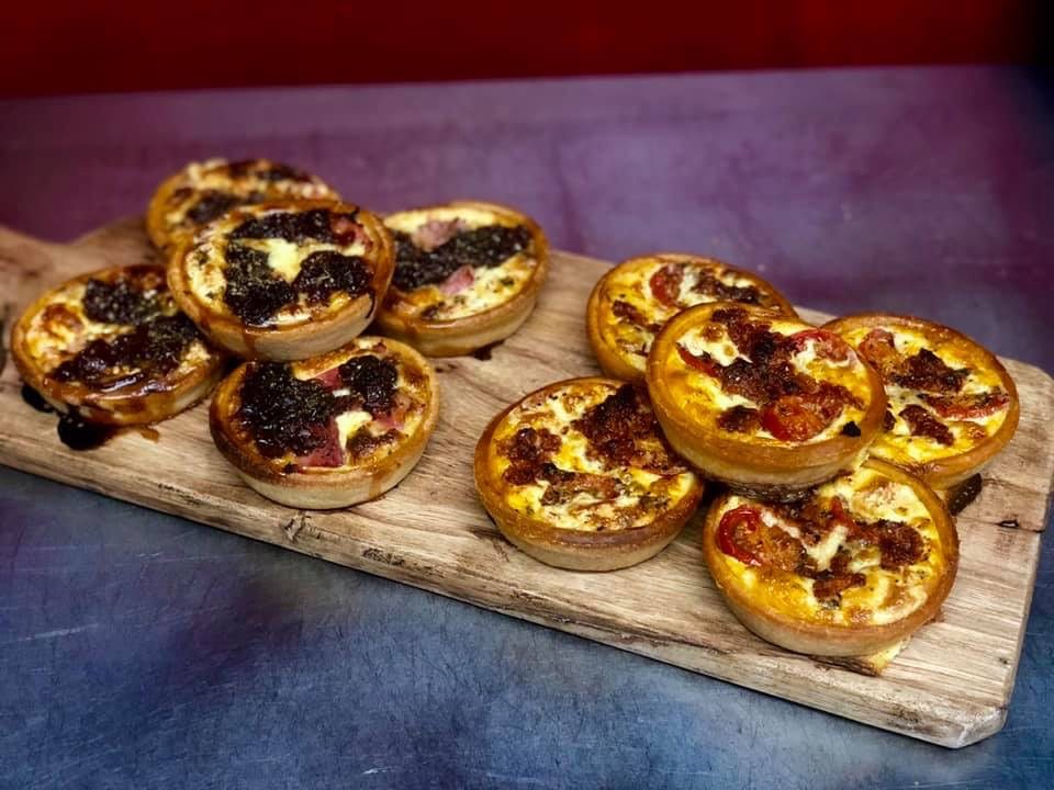 Mini quiches on a wooden board